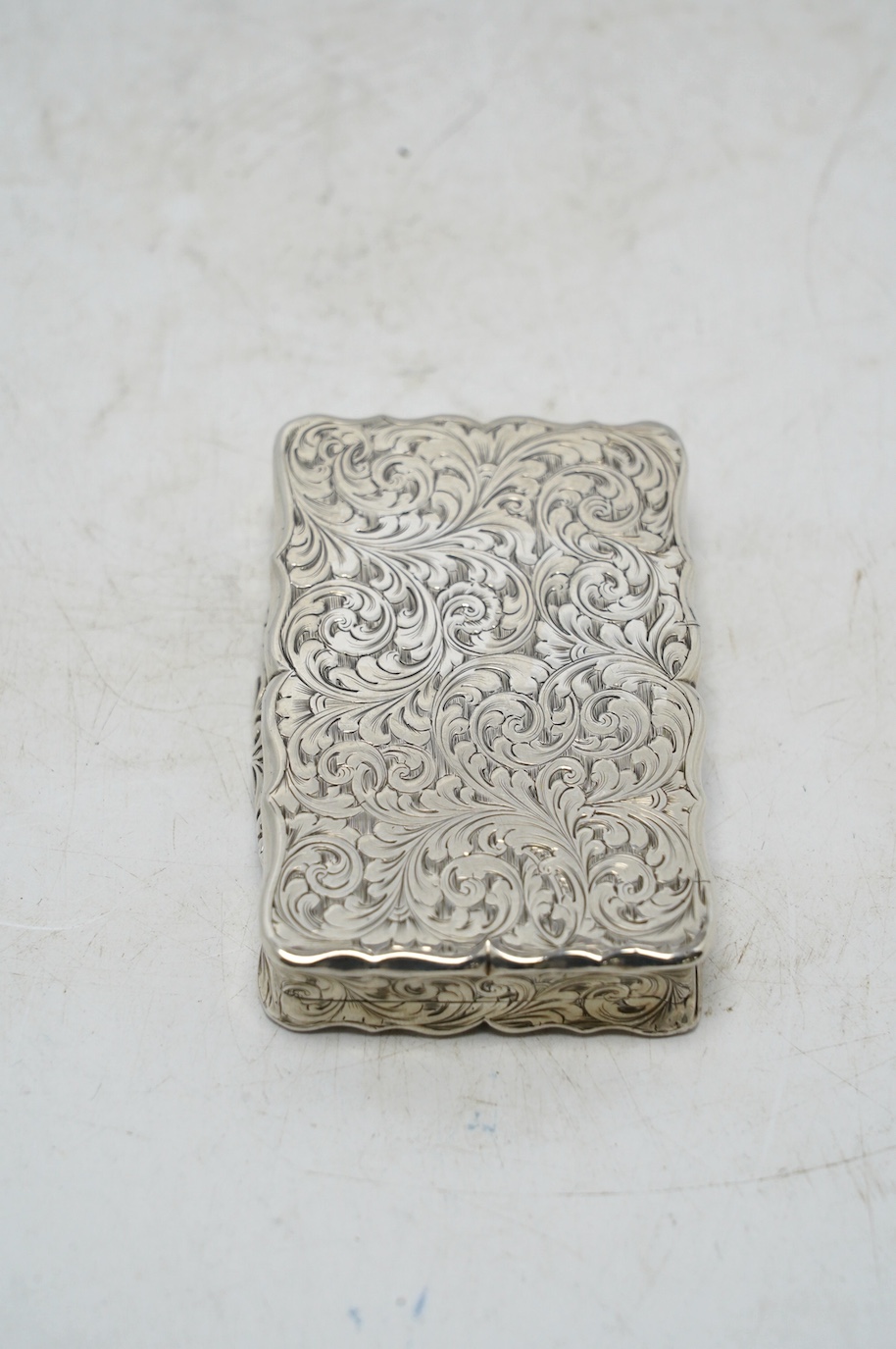 A Victorian engraved silver snuff box, by Nathaniel Mills, Birmingham, 1851, 66mm. Condition - fair